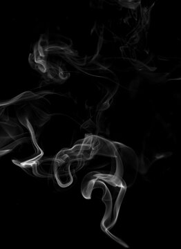 Abstract white smoke swirling on black background, smooth flowing vapor texture with soft curves and dynamic movement. Elegant mist pattern ideal for dark background design, mystery, atmosphere