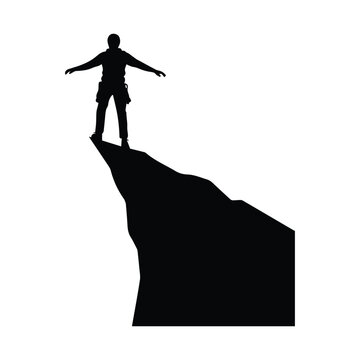 Person standing on edge of mountain cliff with arms outstretched