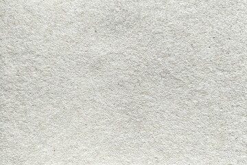 Fototapeta premium Close-up of recycled white paper texture background with organic fiber grains.