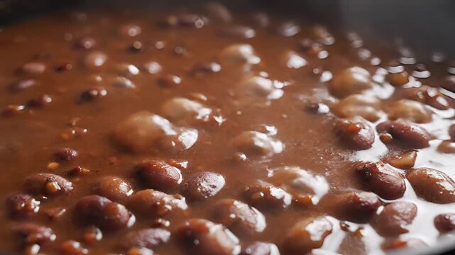 Closeup of Bubbling Chocolate Fondue with Nuts.
