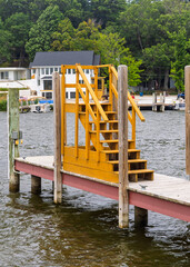 Fototapeta premium Wooden yellow stairs on a boat dock in Michigan marina