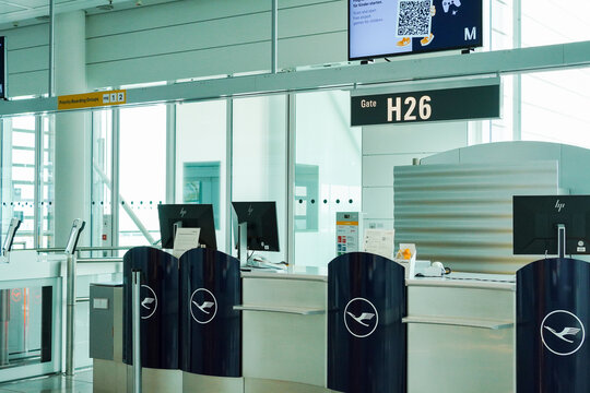 Empty Lufthansa check-in counters at boarding gate H26 in Munich Airport Terminal 2, Germany