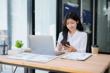 Fototapeta premium Accountant woman working on financial investment on calculator, calculation, business growth analysis and marketing on graph at office.