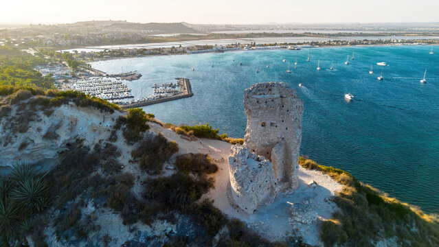 Aerial view of the ruins of Torre del Poetto watchtower on the Sella del Diavolo cliffs overlooking the marina and Poetto beach, Cagliari, Sardinia, Italy