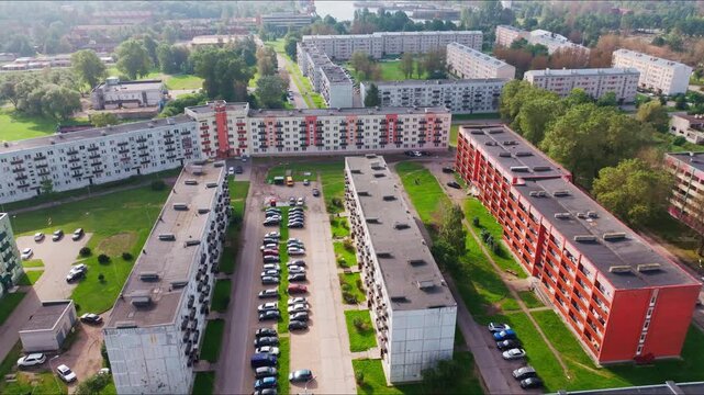 Drone pulls back over Tosmare district showing apartment blocks Liepaja