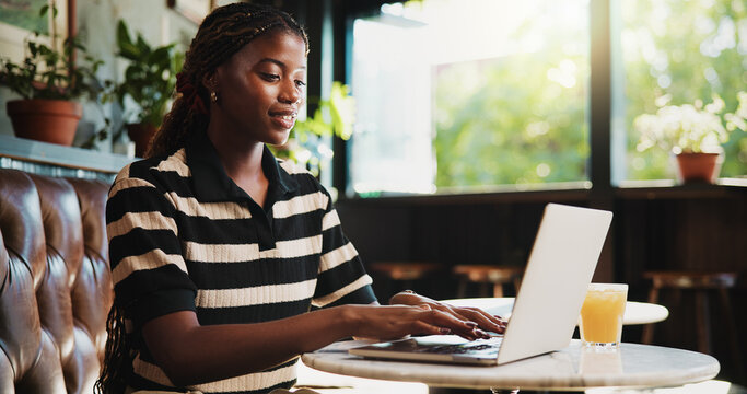 Typing, online and happy woman with laptop in cafe, blog and freelance project on web or ad campaign. Copywriting, smile and black person with technology for article, remote work and creative in shop
