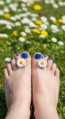 Naklejka premium Bare feet with blue toenails and daisies on green grass field 1