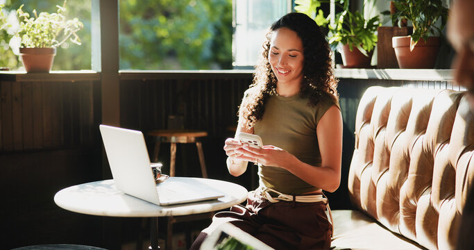 Woman, phone and typing in coffee shop for remote work, trend research and conversation. Freelance person, laptop and chat in cafe for project, communication or social networking in small business