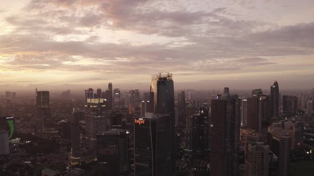 Aerial Sunset View of Jakarta Cityscape with Modern Skyscrapers and Bank BTPN Tower, Indonesia