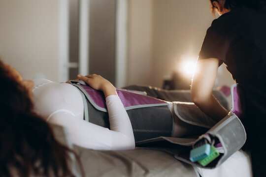 Woman receiving pressotherapy treatment for lymphatic drainage