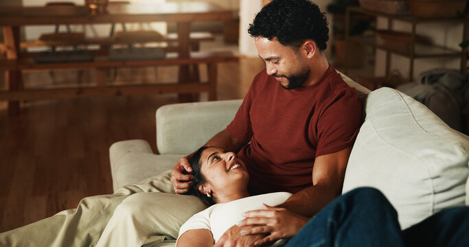 Happy, couple and relax on sofa with love, romantic connection and bonding together on weekend break. People, smile and rest in home with marriage commitment, loyalty and care for partner in lounge.