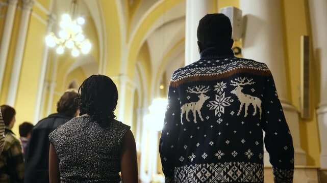 Diverse parishioners celebrating Christmas mass in a beautiful Catholic church interior