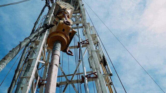 Oil drilling rig working on a sunny day.