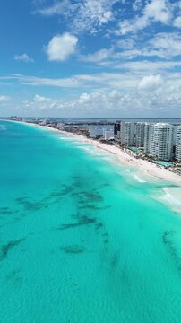 Vertical aerial drone pan of Cancun beach with white sand and turquoise water 4K