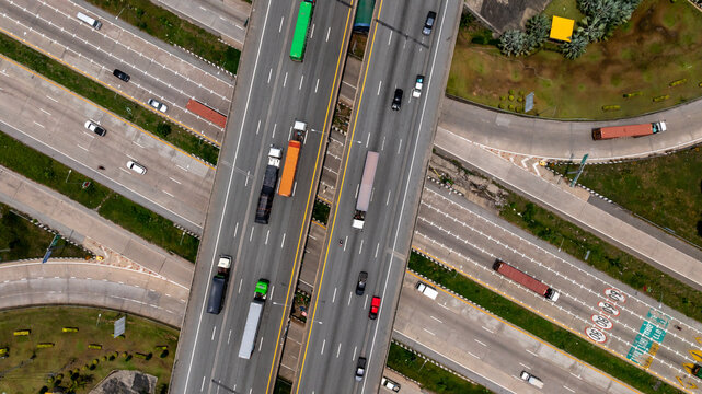 Aerial top view symmetrical highway interchange crossroad highway junction, Highway intersection with traffic intersection, Interchanges elevate transportation highway intersection road express way.