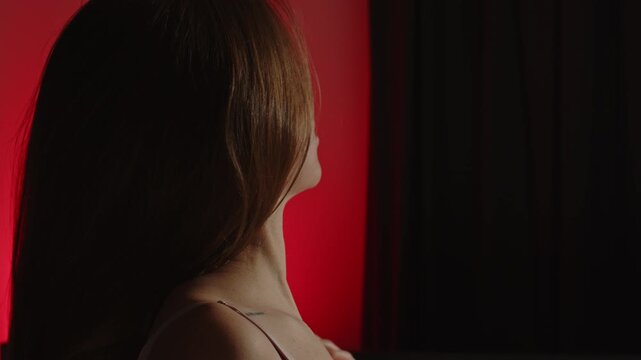 Beautiful portrait of a sensual woman waving her hair in slow motion and slowly undoing her brassiere