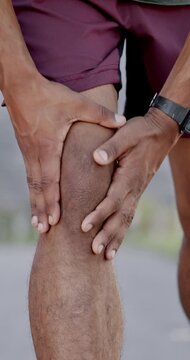 Hands, knee pain and fitness in city with injury on break, rest and stop for tension with exercise in summer. Person, runner and outdoor with joint ache, arthritis or tendinitis on urban street