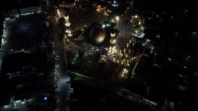 Aerial night view of a crowded illuminated religious site