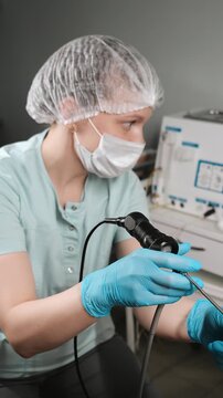 ENT doctor examining patient ear nose and throat using medical equipment in clinic, medical checkup and healthcare diagnosis concept.