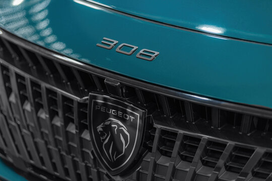 Peugeot 308 logotype on the vehicle front grille. The branding highlights model identity, design language, and automotive engineering