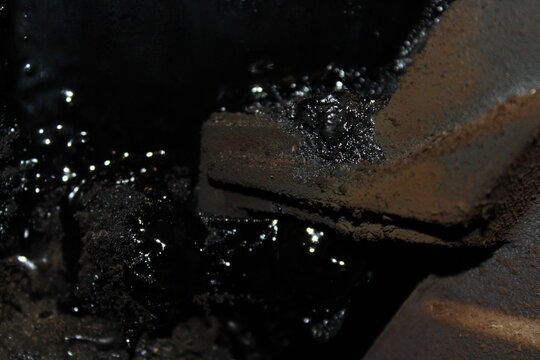 Sticky creosote buildup on a furnace door joint close up