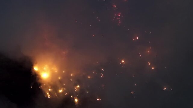 Aerial night drone footage of landfill fire burn