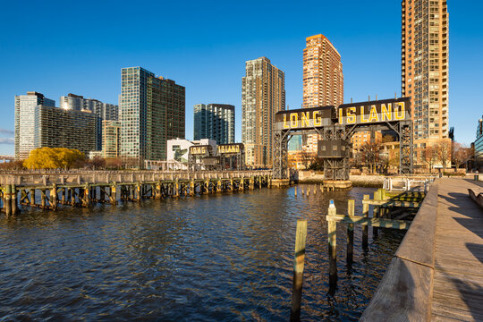Long Island City waterfront at Gantry Plaza State Park, Queens, New York City, with iconic gantries, piers and modern residential towers in late day light