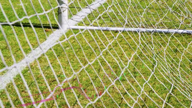 Goal net and post with camera pan starting near post, panning right, revealing colored cords