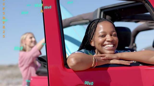 Rider leaning on red car, friend stowing teal board causing teal digits shifting orange for travel