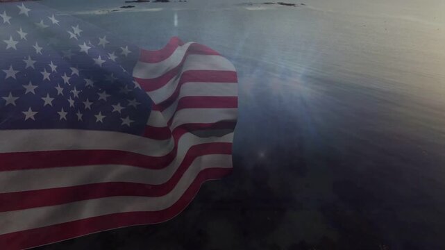 breeze starting US flag rippling and folding, camera showing beam lighting horizon signaling dawn
