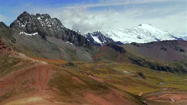 Ausangate Glacier Peruvian Andes landscape Peru's Vinicunca Rainbow Mountain Vilcanota Range mountains near Quelccaya Ice Caps sunny bluesky morning clouds stunning valley panorama scenery static shot