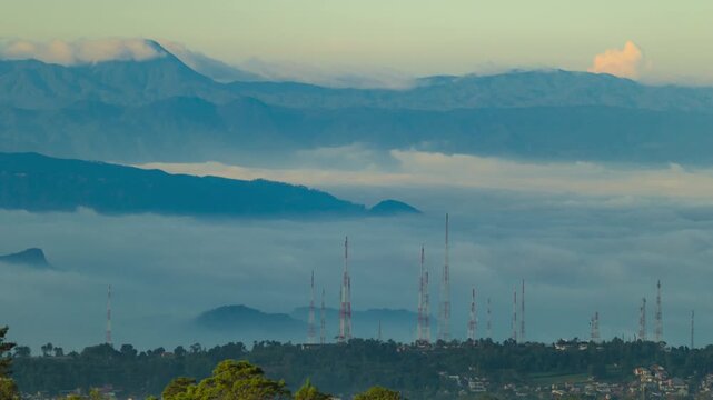 Cinematic 4K timelapse of broadcast transmitter towers on hillside with sunrise glow, relay antennas and wireless communication infrastructure in mountains