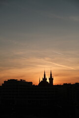 Naklejka premium Silhouetted Cityscape At Golden Sunset Hour