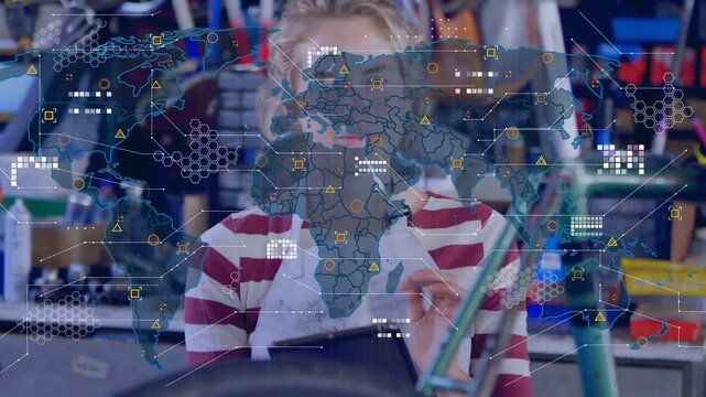 Tech holding tablet behind bike wheel, tapping and activating map HUD while checking repair data