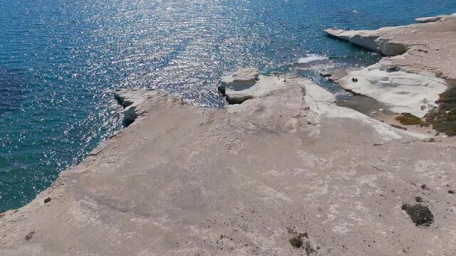 Aerial Boomerang Flight Pulling Back from White Limestone Cliffs and Blue Sea in Limassol Cyprus
