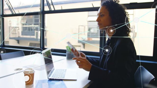 Network overlays appearing, woman typing on laptop then picking up phone, calling for tech sync