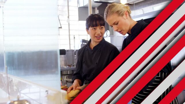 Moving graphic clearing two chefs slicing bread at counter, left chef showing right chef training
