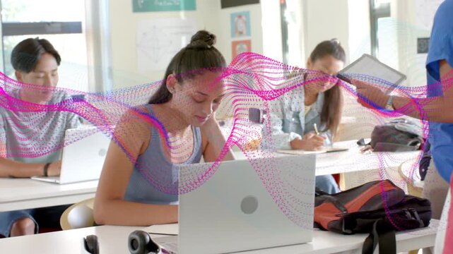 Teacher waving tablet urging center student typing or writing laptop in class magenta wave overlayin