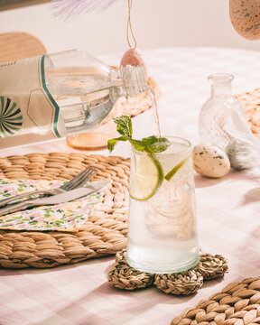 fizzy drink being poured into a glass on an Easter decorated table