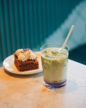 matcha latte and cake on a table in a cafe