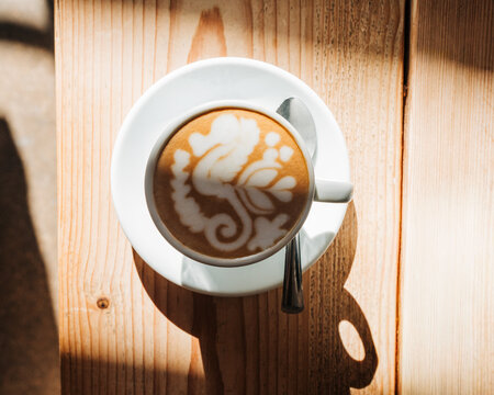 beautiful artisan coffee art on a wooden table in a cafe in England