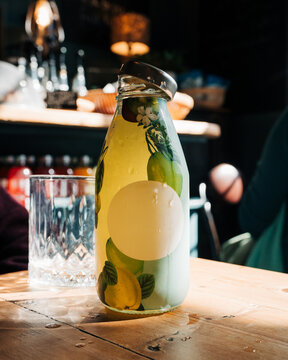 bottle of a fruity soft drink glowing in the sun on a cafe table