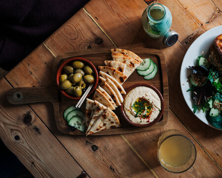 pitta bead flat bread board with olives and humous in a cafe