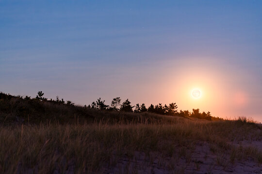 Supermoon rise over beach dunes in October 2024