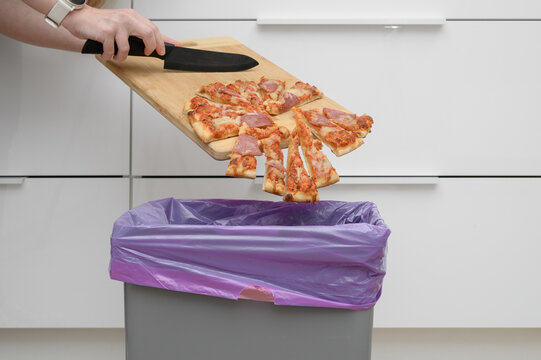 Throwing food in the trash, unappetizing greasy pizza