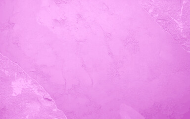 Fototapeta premium A pink grunge wall background with a few specks of white. The background is a solid pink color