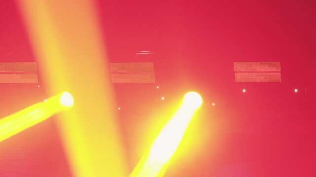 Lively nightclub scene. Exciting nightlife environment filled with colorful moving lights and music. Bustling nighttime setting featuring lively lighting effects and energetic dance audience