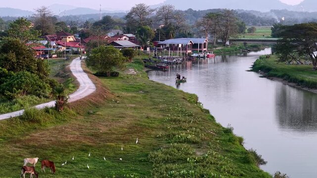 Drone aerial view of Labuh Banting riverside village and boats