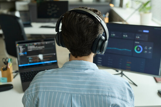 Programmer analyzing chart on computer in the office