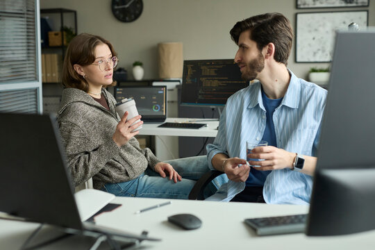 Professional colleague conversation during an office coffee break